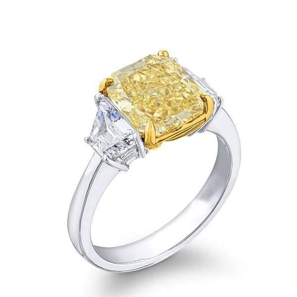 three stone diamond engagement ring with step cut trapezoid side stones and fancy yellow radiant