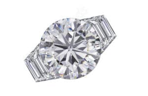 brilliant round cut three stone ring with step cut trapezoid side stones